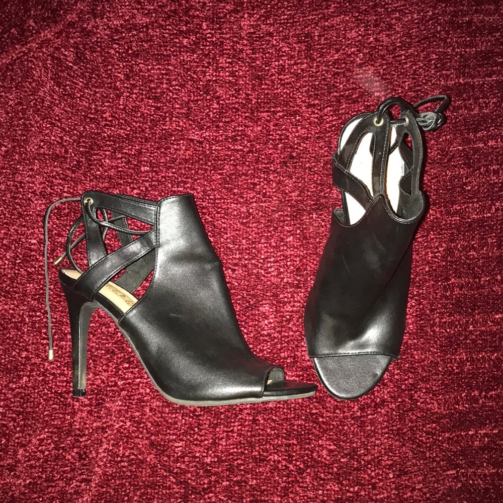 Brash black leather ankle-tie heels